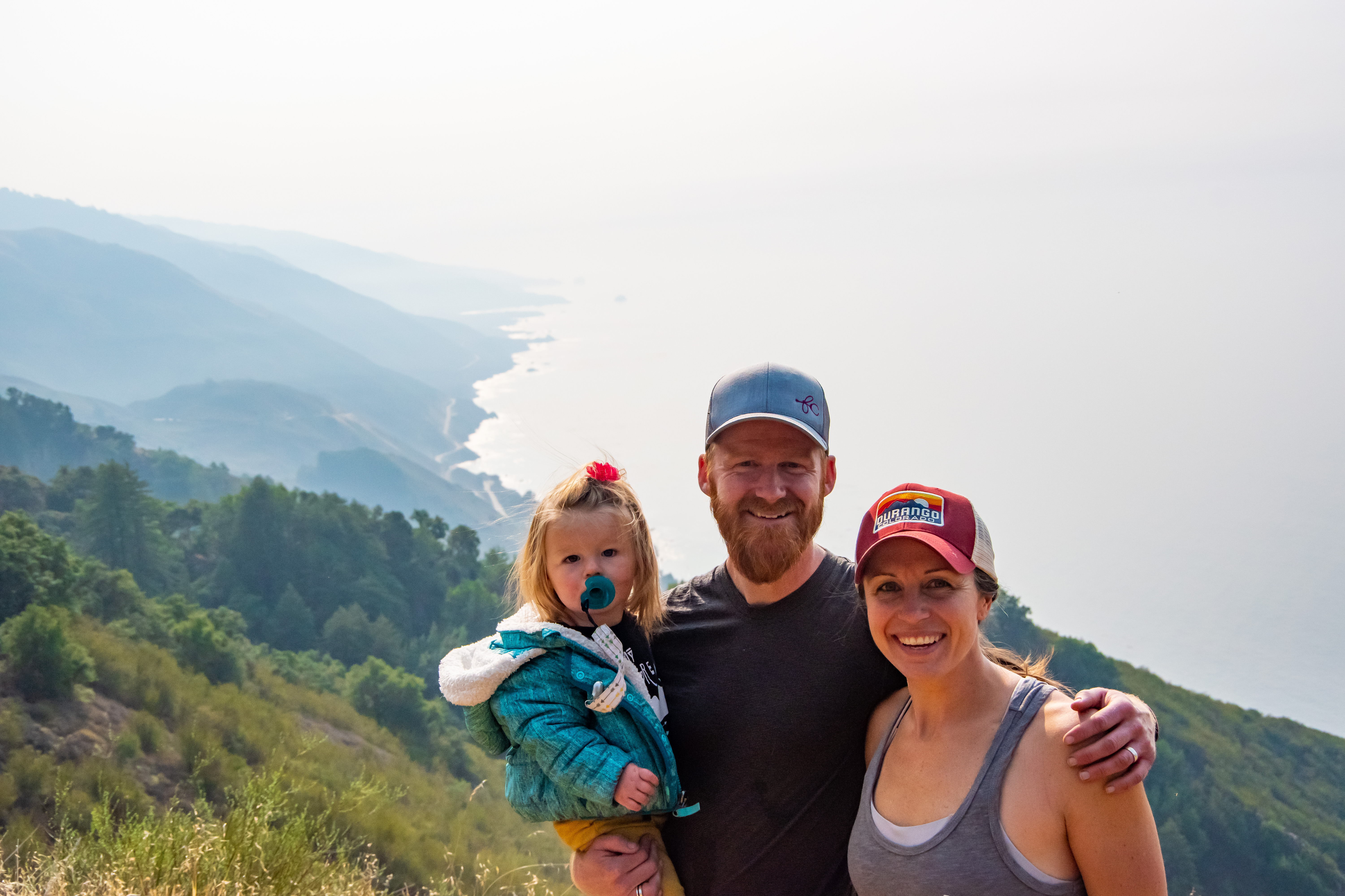 Family on cliffs overlooking Big Sur